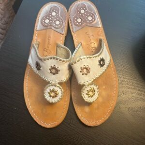 White with metallic accents Jack Rodger’s sandals